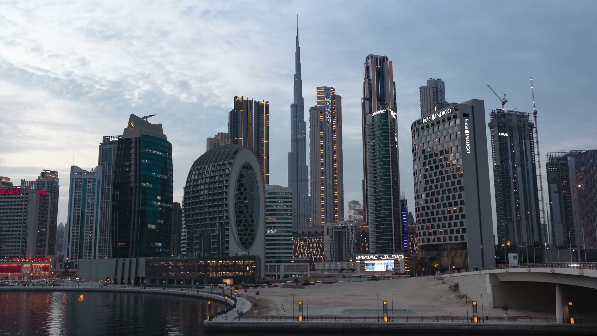 Downtown Dubai skyline with Burj Khalifa transitioning from sunset into night