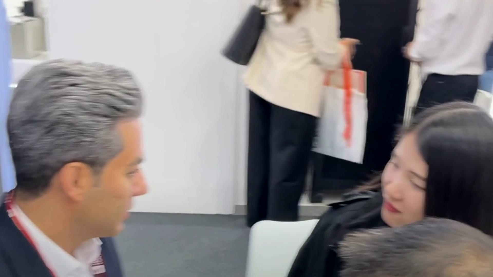 Saeid Soleimani in conversation with partners at an industry trade show